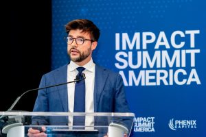 Professional corporate event photography of speaker presenting at summit conference in NYC