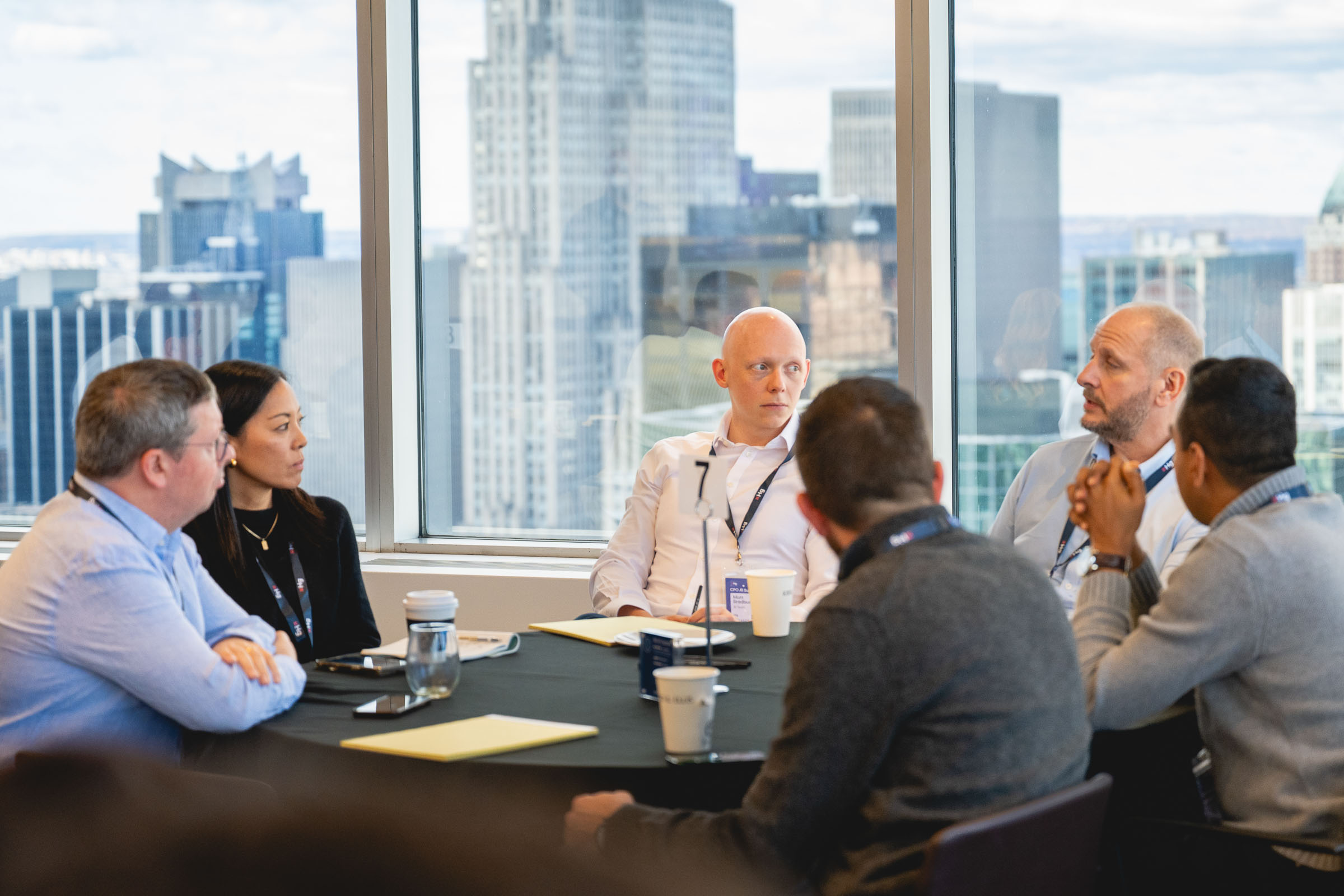 Professional networking between sessions at a corporate conference.