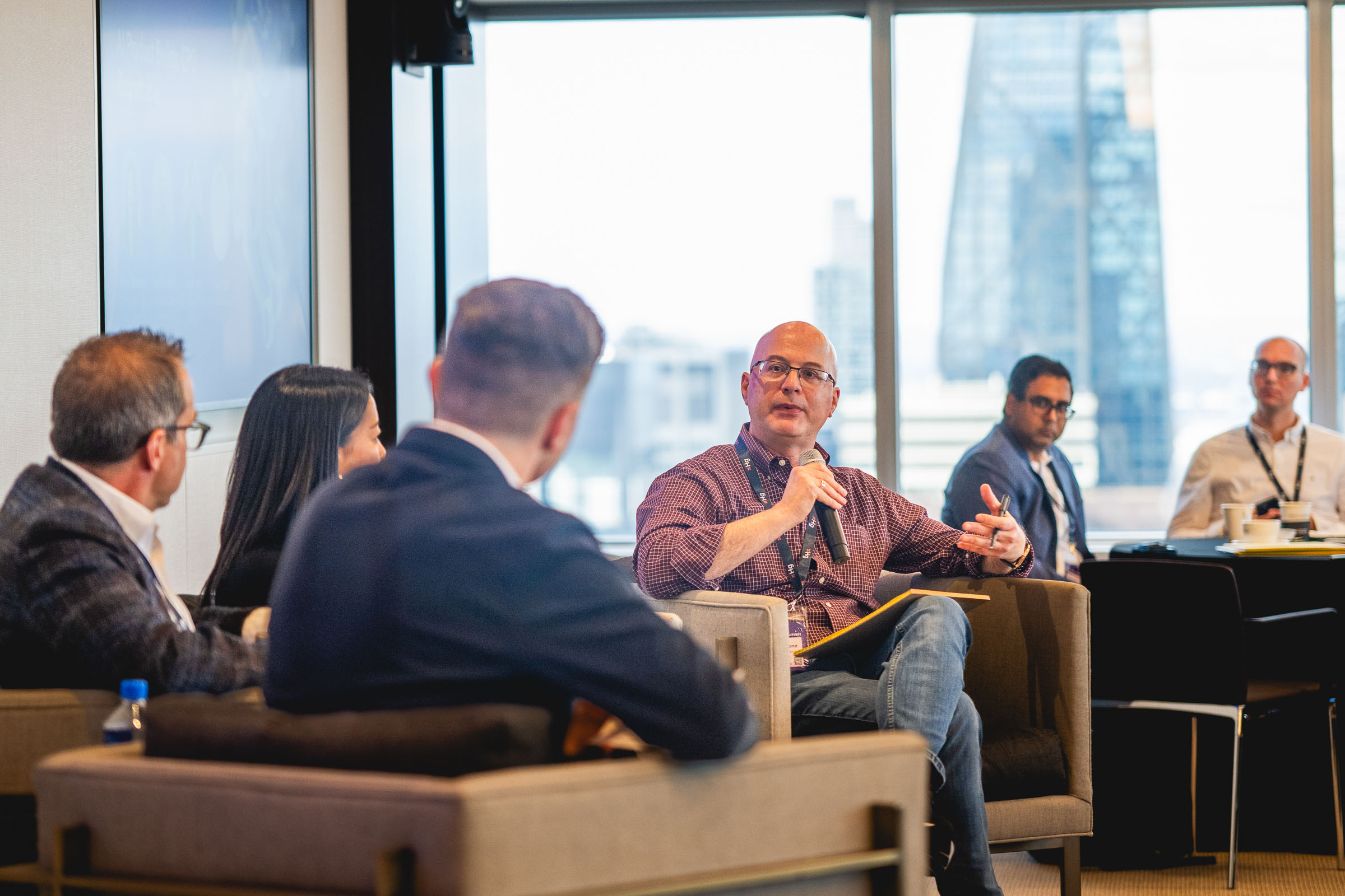 Corporate panel discussion with multiple speakers on stage at business conference in New York City
