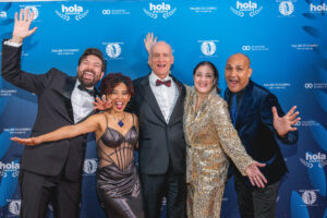 Guests posing at step-and-repeat backdrop during HOLA Awards event in New York City
