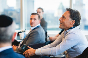 Audience member asking a question during corporate conference panel in New York City